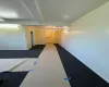 Hall featuring beamed ceiling, an inviting chandelier, and dark carpet