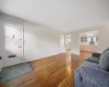 Unfurnished room with ceiling fan, light wood-type flooring, and radiator