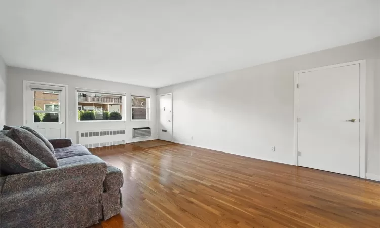 Living room featuring radiator and hardwood / wood-style floors