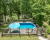 View of pool with a deck and a lawn