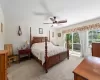 Bedroom featuring Carpeted, ceiling fan, and access to deck