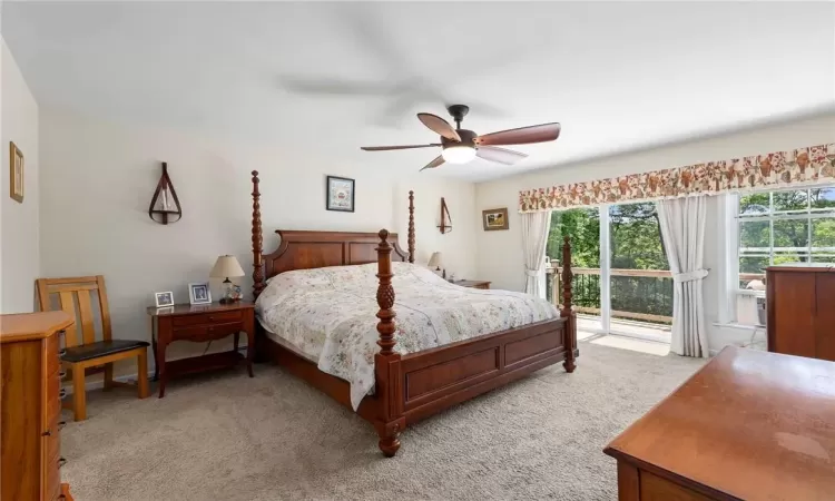 Bedroom featuring Carpeted, ceiling fan, and access to deck