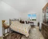 Bedroom featuring baseboard heating and light hardwood / wood-style floors