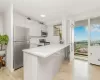 Kitchen featuring stainless steel appliances, white cabinetry, light hardwood / wood-style flooring, decorative backsplash, and kitchen peninsula