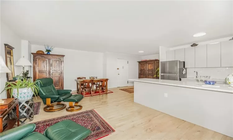 Living room featuring sink and light hardwood / wood-style floors