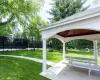 View of property's community with a yard and a gazebo