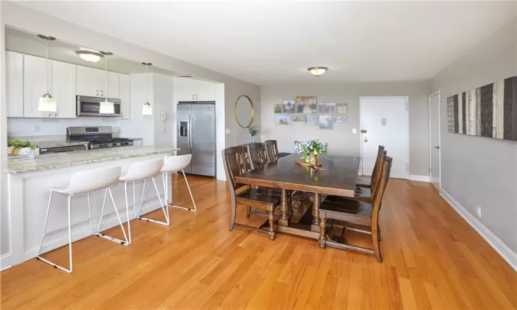 Dining room with light hardwood / wood-style floors