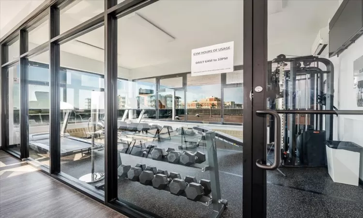 Gym with dark wood-type flooring