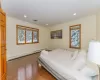 Bedroom featuring dark hardwood / wood-style flooring, a baseboard radiator, and ornamental molding