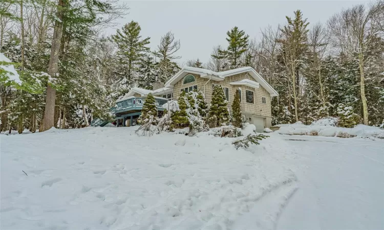 View of snow covered exterior featuring a garage