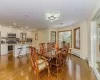 Dining area with wood-type flooring and baseboard heating