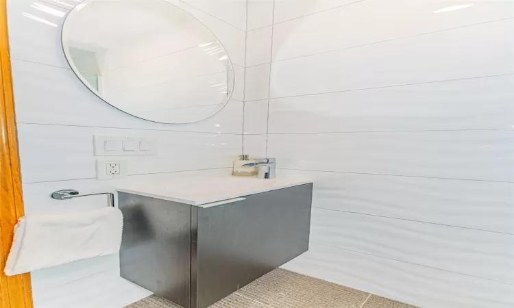 Bathroom with tile patterned floors and vanity