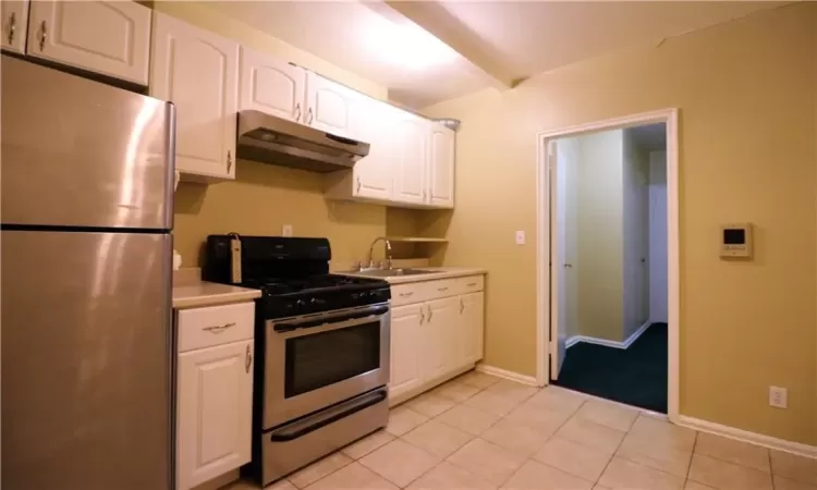 Bathroom featuring vanity and shower / bathtub combination with curtain