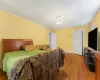 Bedroom featuring ceiling fan, crown molding, and hardwood / wood-style flooring