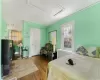 Bedroom featuring hardwood / wood-style flooring, ceiling fan, and crown molding