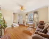 Dining room with ceiling fan, wood-type flooring, ornamental molding, and a baseboard heating unit