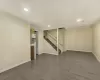 Basement with light wood-type flooring and crown molding