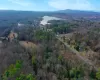 Birds eye view of property featuring a water and mountain view