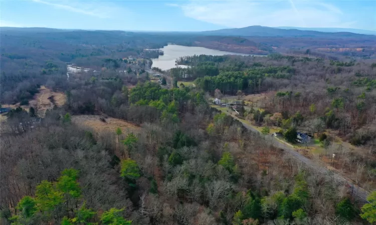 Birds eye view of property featuring a water and mountain view