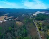 Birds eye view of property with a water and mountain view