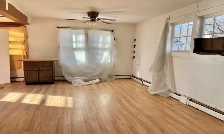 Unfurnished dining area with ceiling fan and light hardwood / wood-style floors