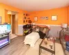 Living room with view of half bath door and entry to kitchen.