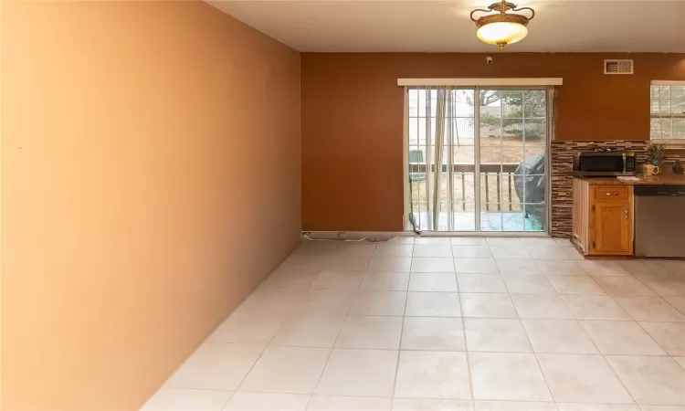 View from top of 1st flight stairs with dining area.