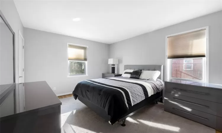 Living area featuring radiator heating unit, a fireplace, wood finished floors, and baseboards