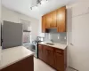 Hallway featuring radiator heating unit, light wood-style flooring, and baseboards