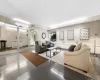 Living area featuring baseboards, light wood-style flooring, and radiator heating unit