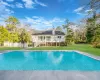 View of pool with a sunroom and a yard