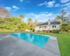 View of swimming pool with a lawn and a wooden deck