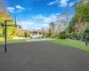 View of basketball court featuring a yard and a swimming pool