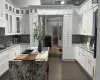 Kitchen featuring light stone countertops and white cabinets