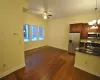 Kitchen featuring ceiling fan with notable chandelier, sink, dark hardwood / wood-style floors, decorative light fixtures, and stainless steel appliances