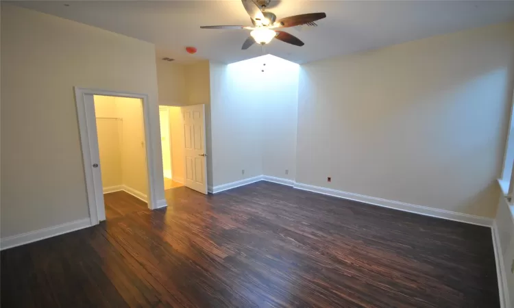 Unfurnished bedroom featuring ceiling fan and dark hardwood / wood-style flooring