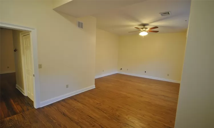 Spare room with ceiling fan and dark hardwood / wood-style flooring