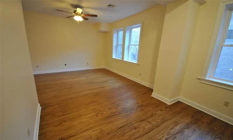 Unfurnished room featuring hardwood / wood-style floors and ceiling fan