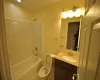 Full bathroom with tile patterned flooring, vanity,  shower combination, and toilet