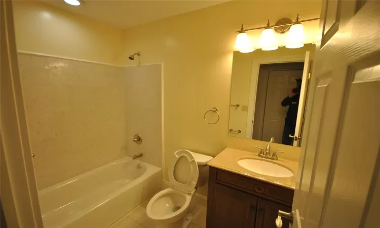 Full bathroom with tile patterned flooring, vanity,  shower combination, and toilet