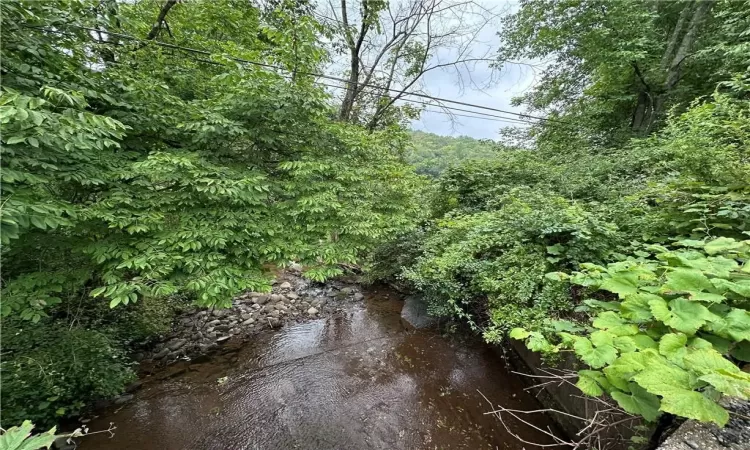 Panther Rock Brook runs along the front perimeter of the lot.