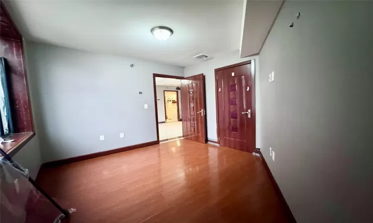 Unfurnished room featuring wood-type flooring