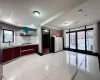 Kitchen with backsplash, white gas cooktop, light tile patterned flooring, and extractor fan