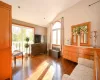 Sitting room with dark hardwood / wood-style floors and vaulted ceiling