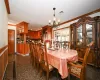 Dining room with ornamental molding and an inviting chandelier