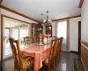 Dining area with crown molding, a wealth of natural light, and a chandelier