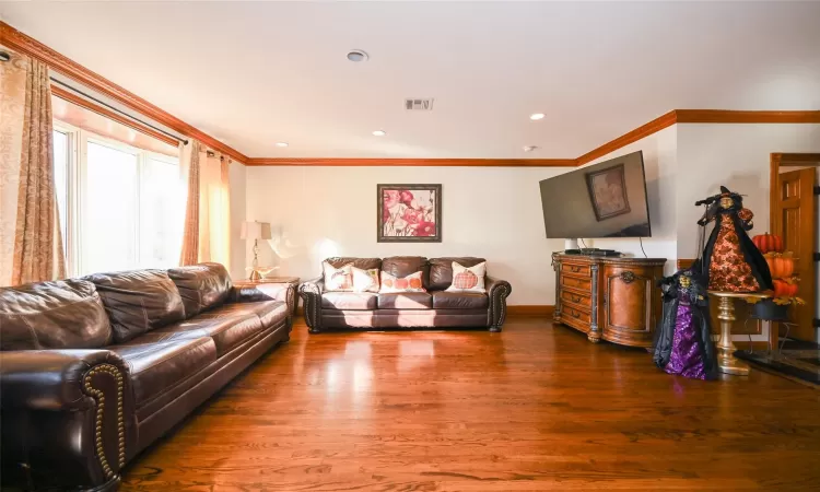 Living room featuring hardwood / wood-style floors and ornamental molding