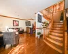 Living room with hardwood / wood-style floors and crown molding