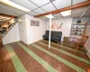 Basement featuring a paneled ceiling and wooden walls