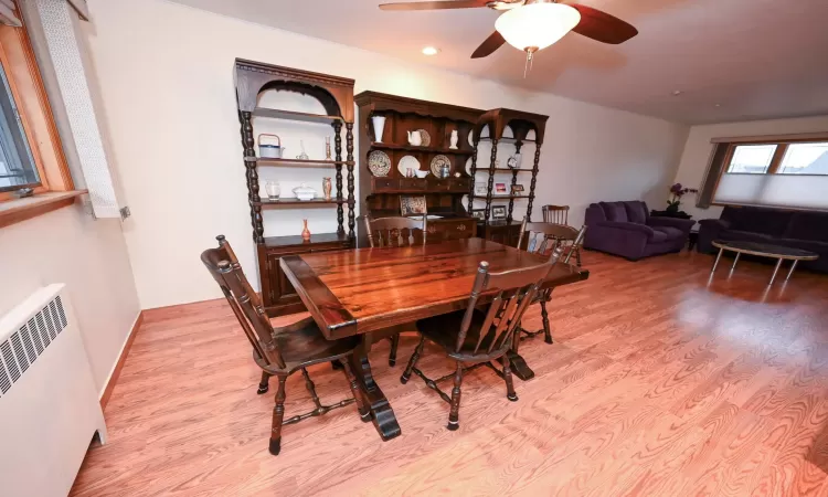 Dining area with radiator, ceiling fan, and light hardwood / wood-style flooring